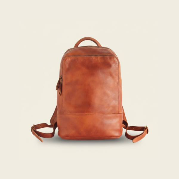 Brown top-grain leather travel backpack, studio photograph on cream background