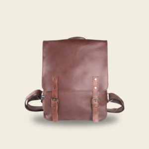 Navy brown vegan PU leather travel laptop backpack, studio photograph on cream background