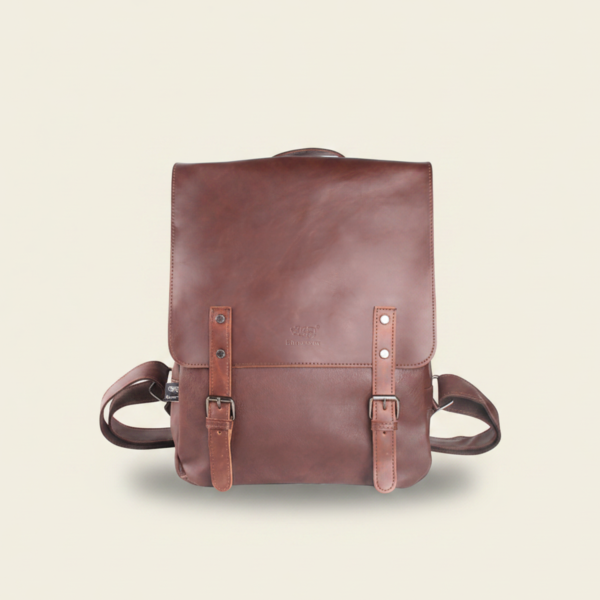 Navy brown vegan PU leather travel laptop backpack, studio photograph on cream background