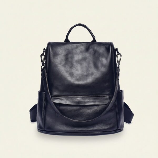 The Nomad convertible leather backpack in retro black on cream background