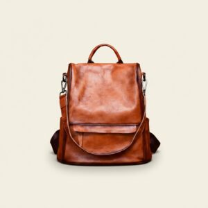 The Nomad convertible full-grain leather backpack in vintage brown on cream background