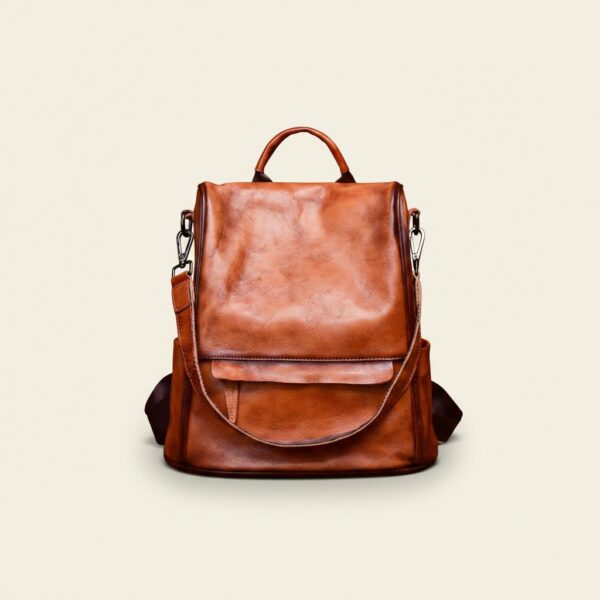 The Nomad convertible full-grain leather backpack in vintage brown on cream background